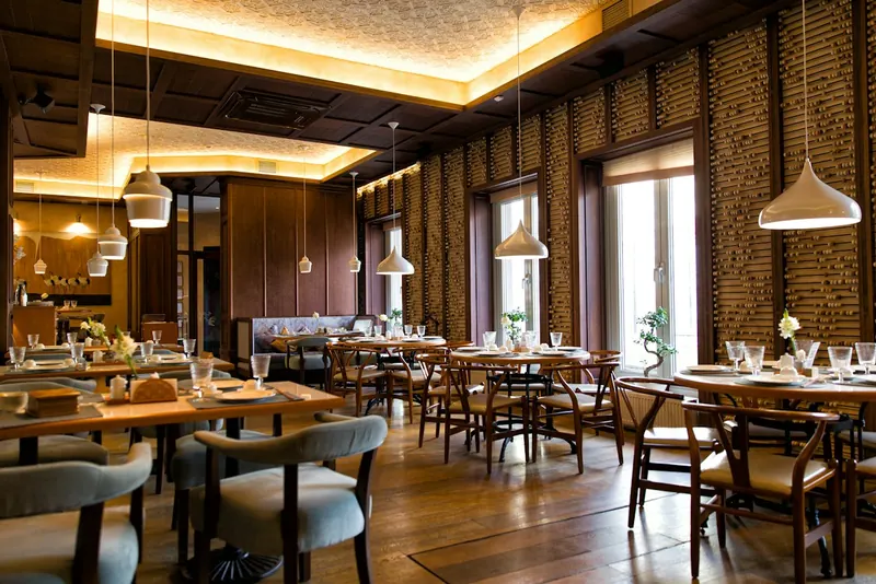 Restaurant dining room with warm pendant lighting
